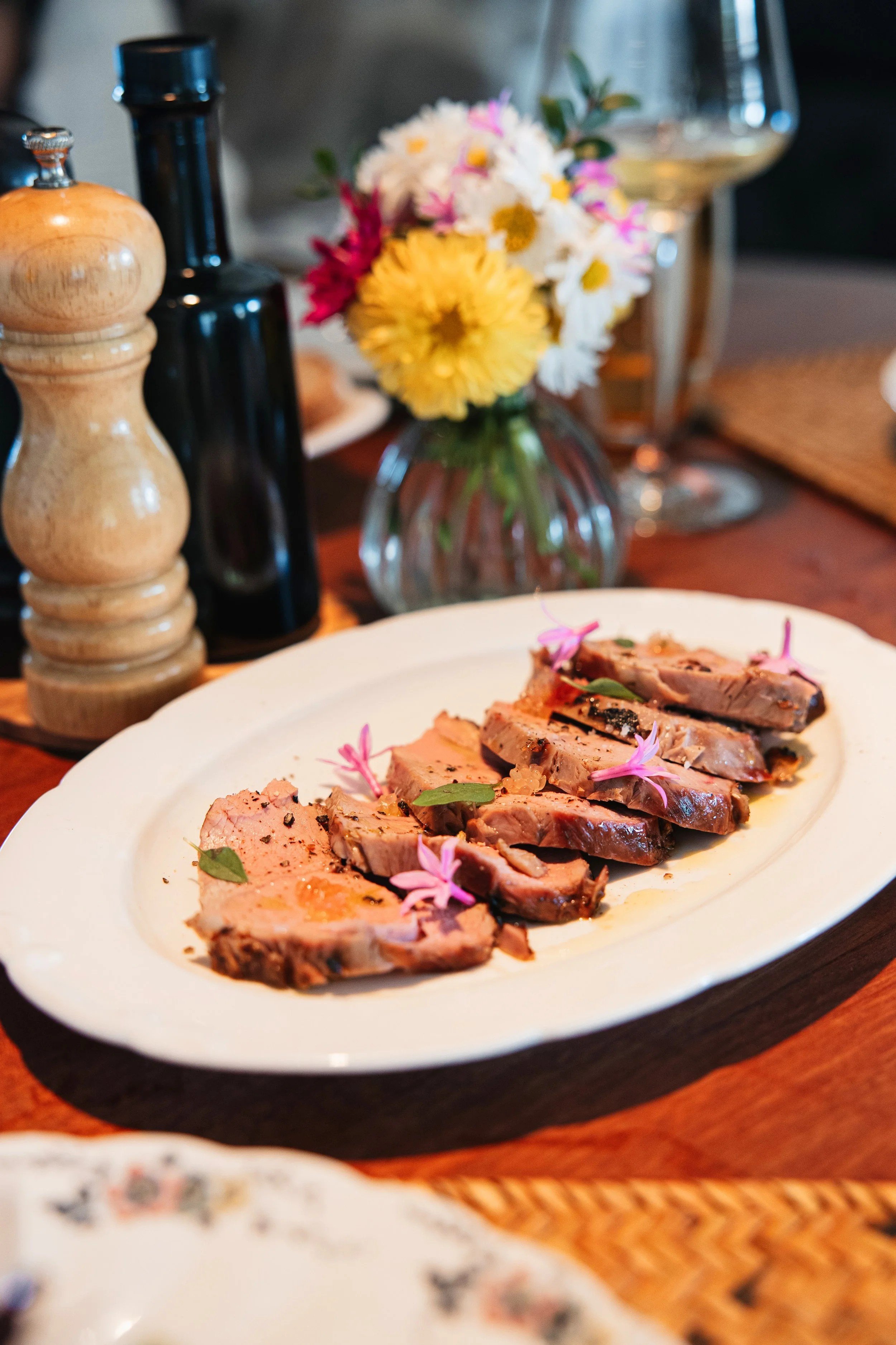 A seed-to-plate dish on the table with flowers cut from the garden