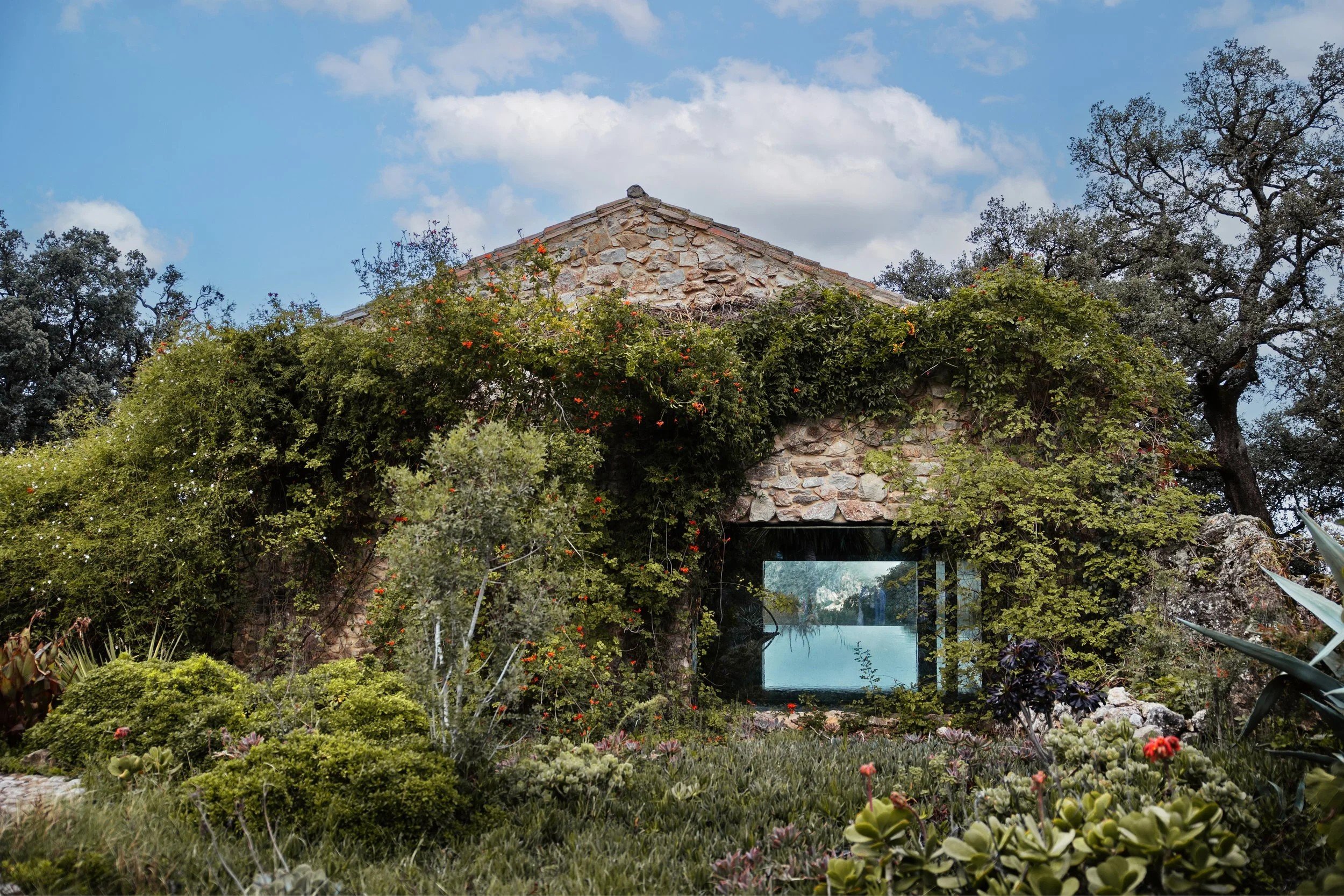 The spa pool seen through a glass wall set into an old stone building