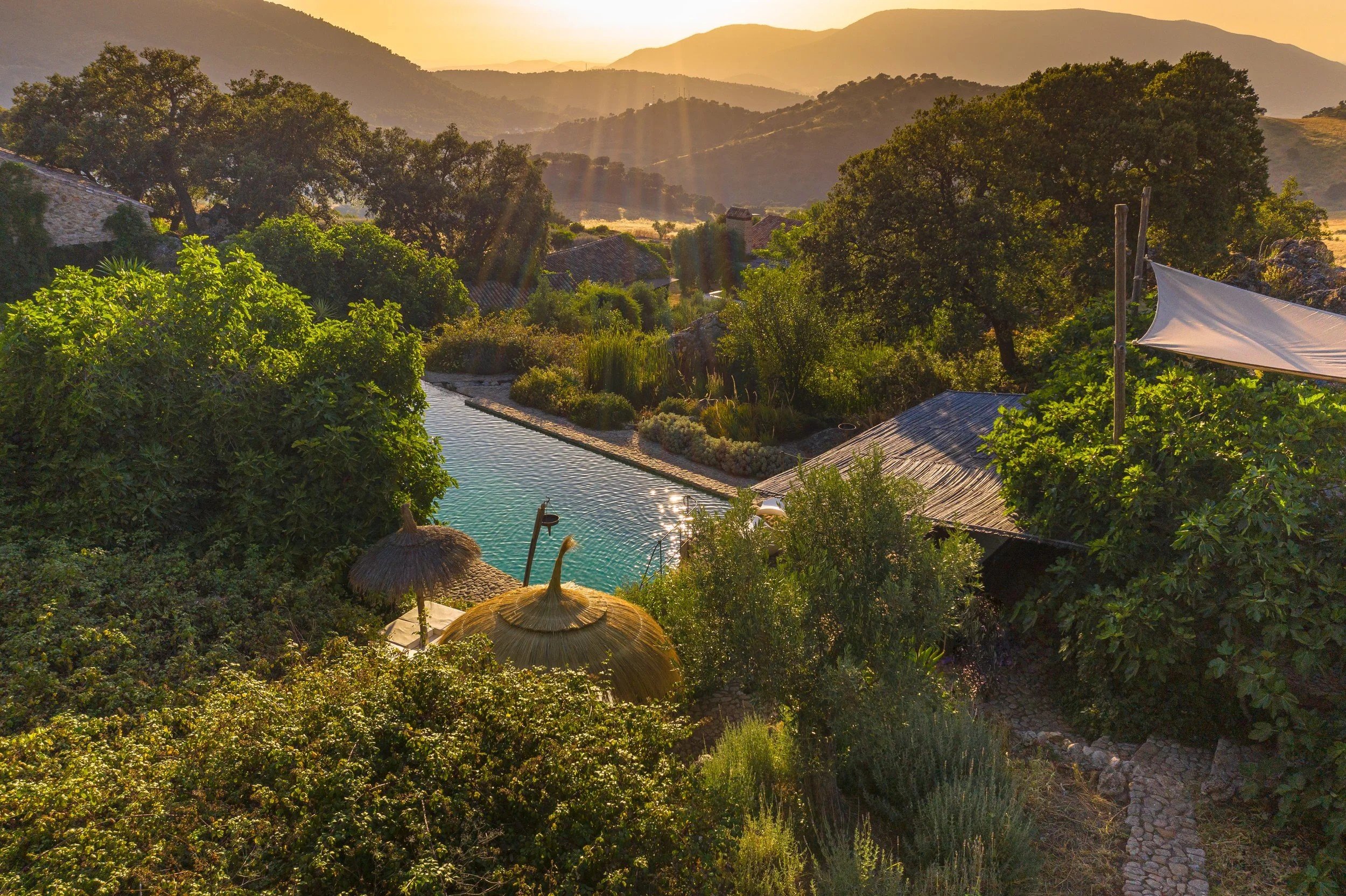 The natural swimming pool above the valley at sunset