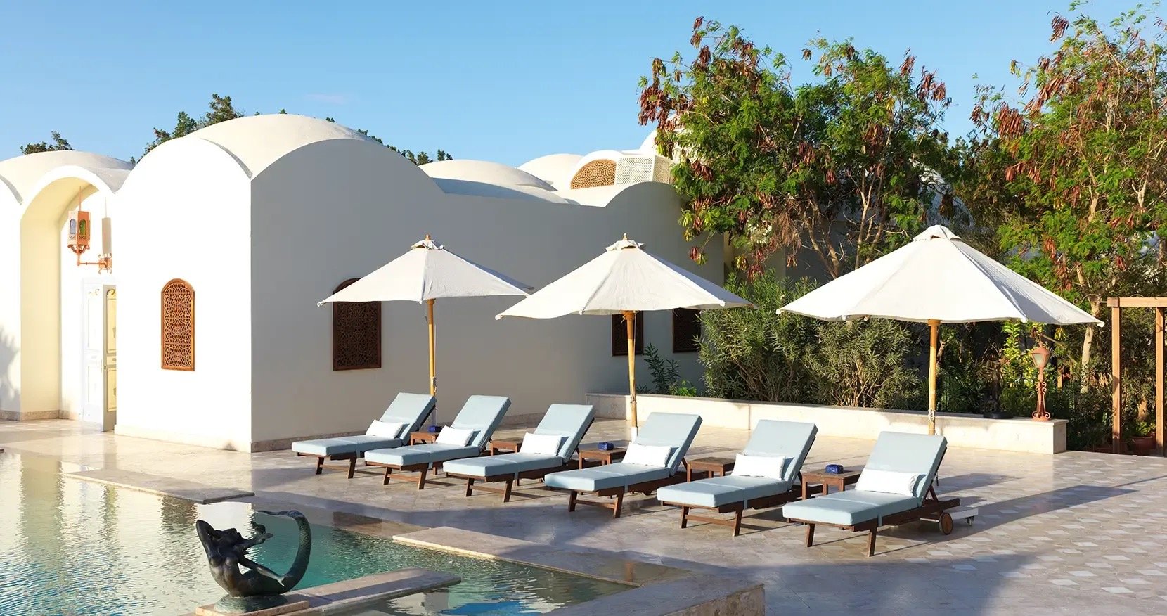 The heated pool below white domed roofs and latticed windows