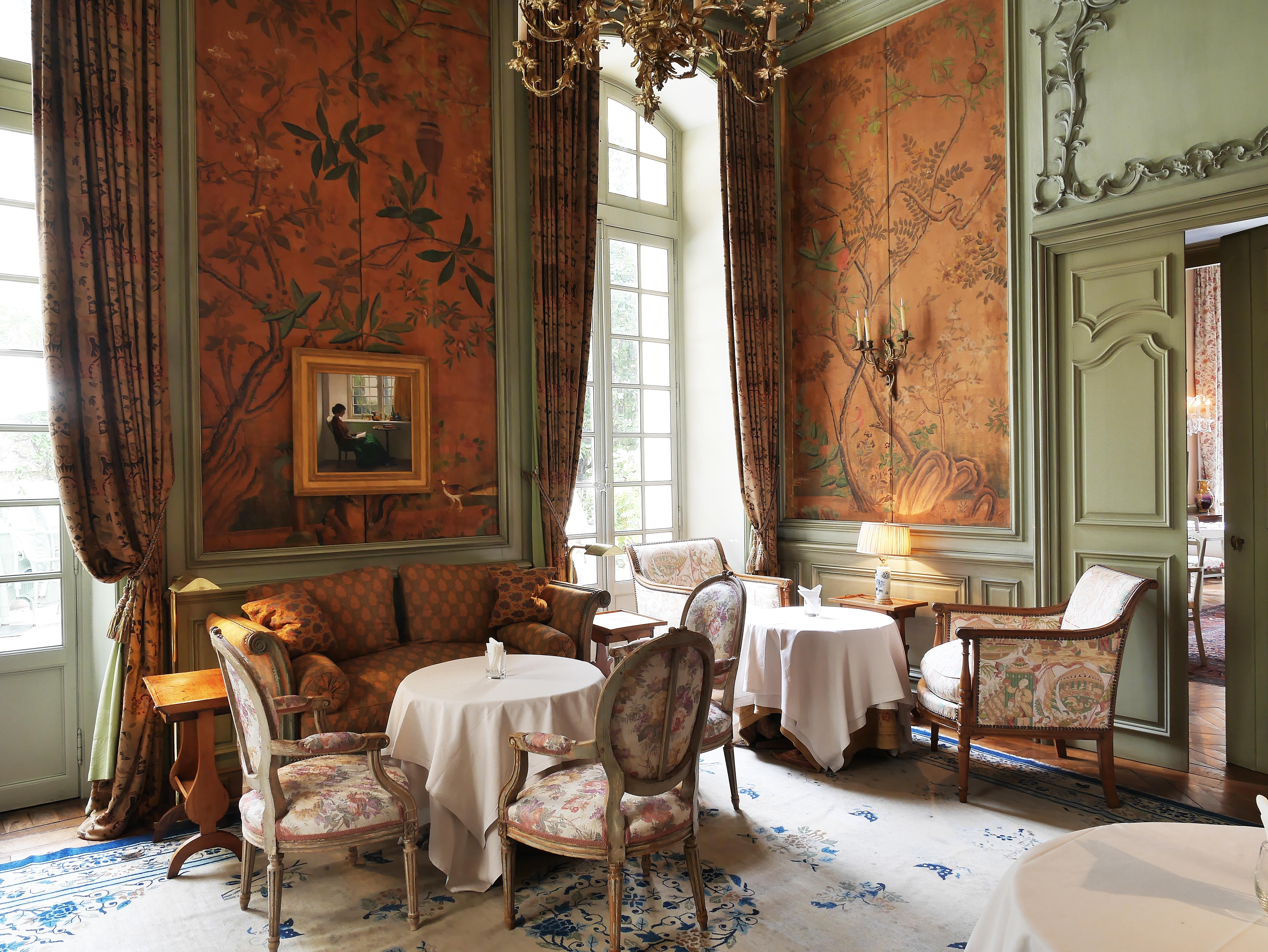 A salon with hand-painted panels and eighteenth-century furniture
