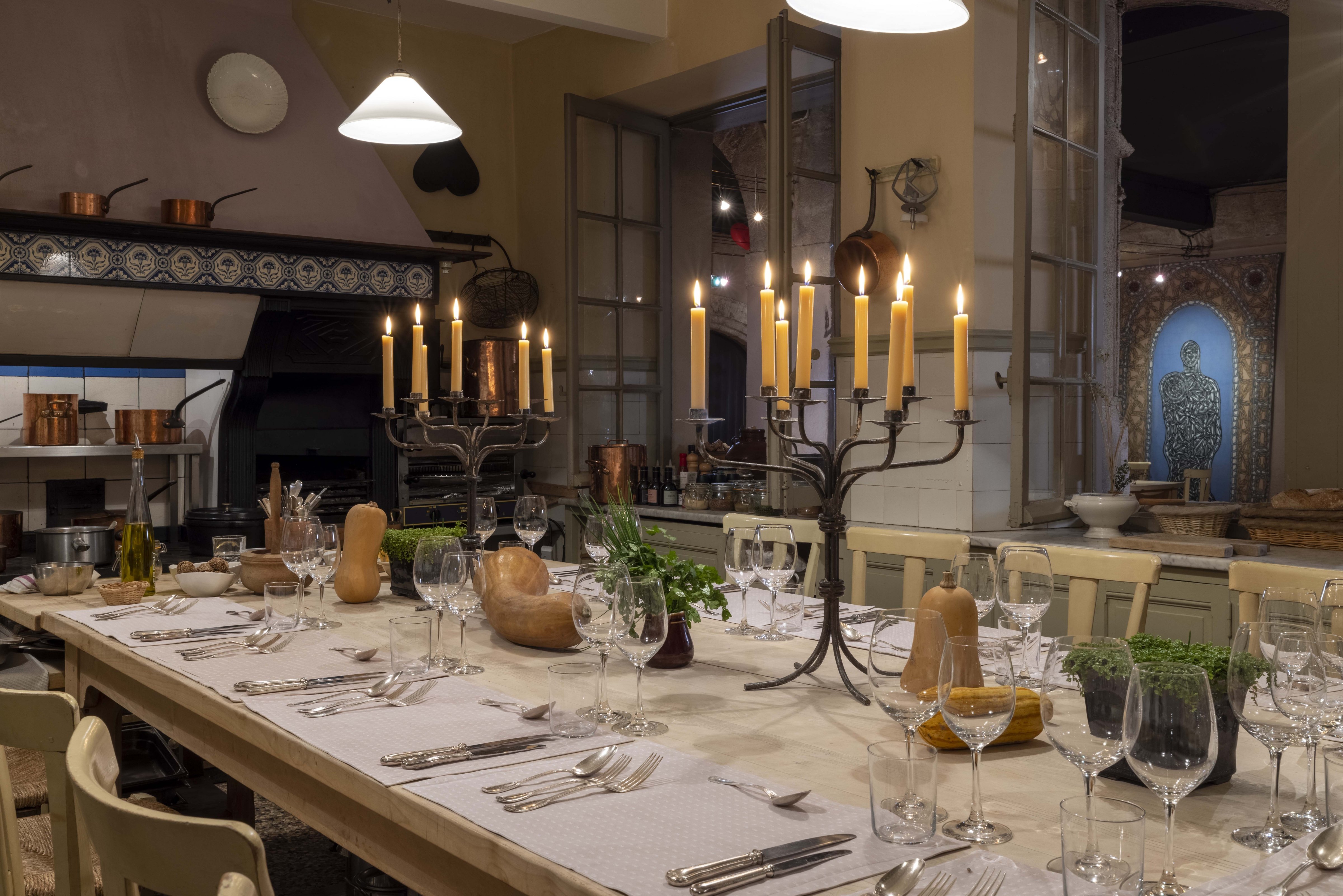 La Table Haute laid by candlelight in the original kitchen