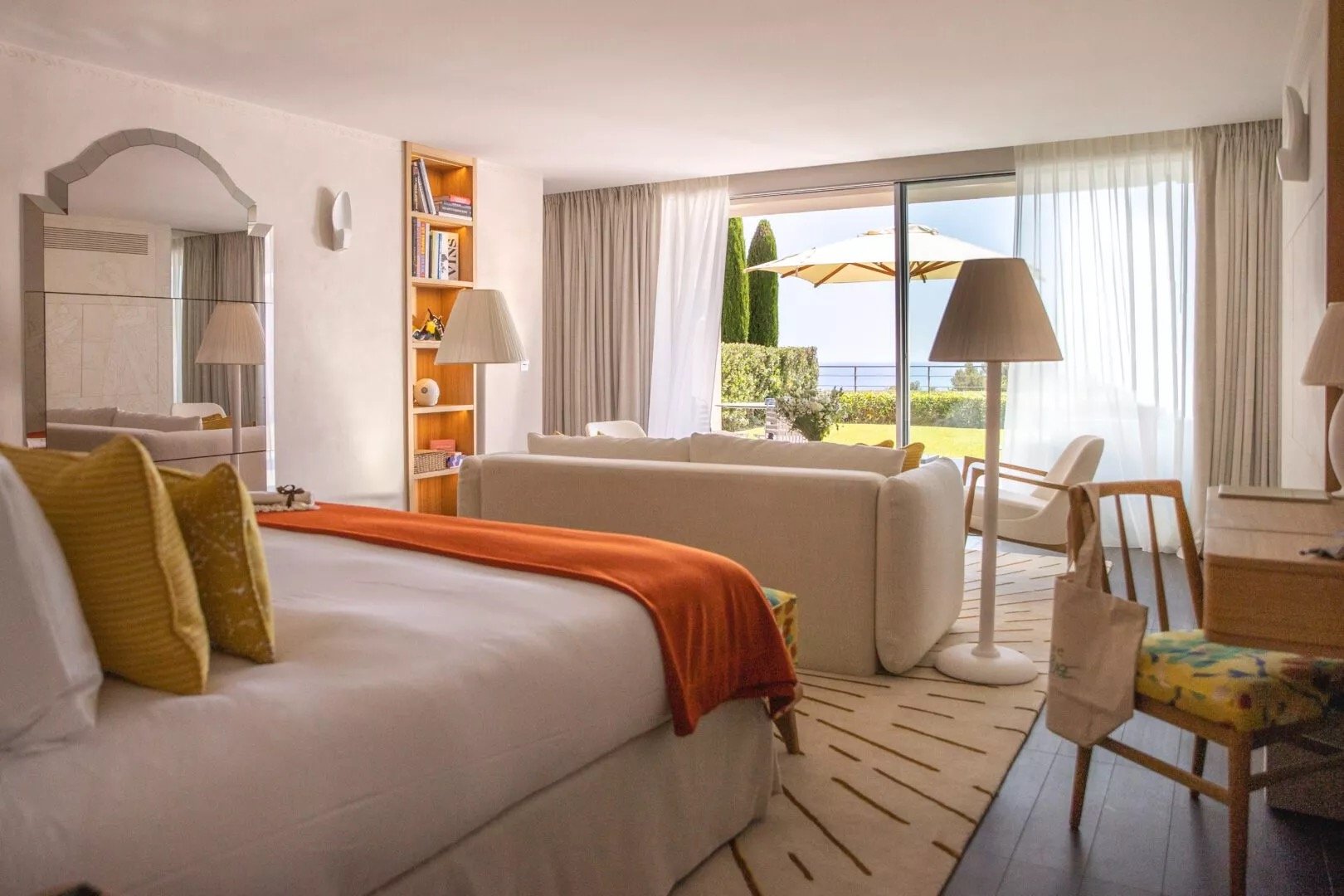 A room in cream and pale wood with a sea-facing terrace
