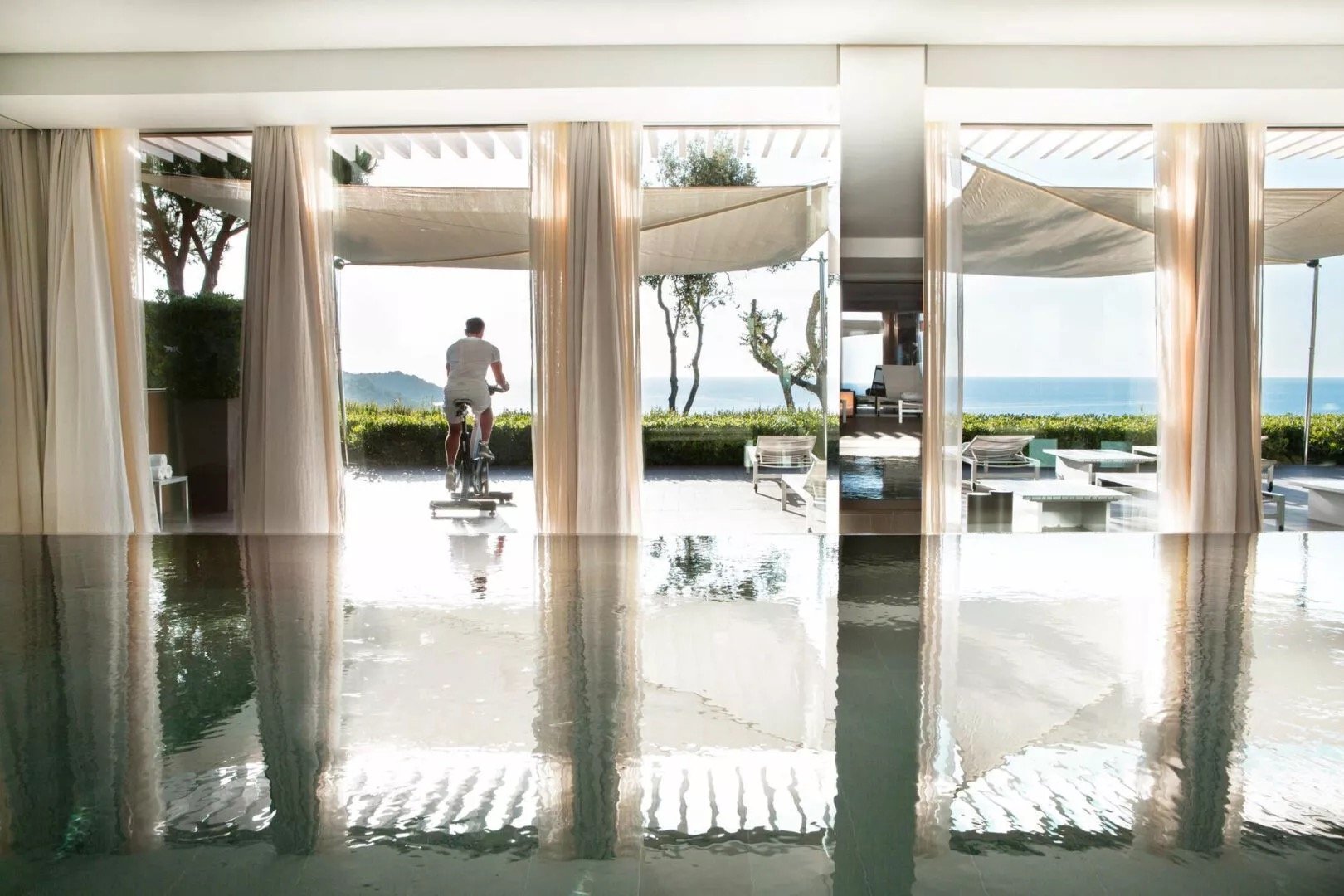 The spa's indoor pool looking out to the garden and sea
