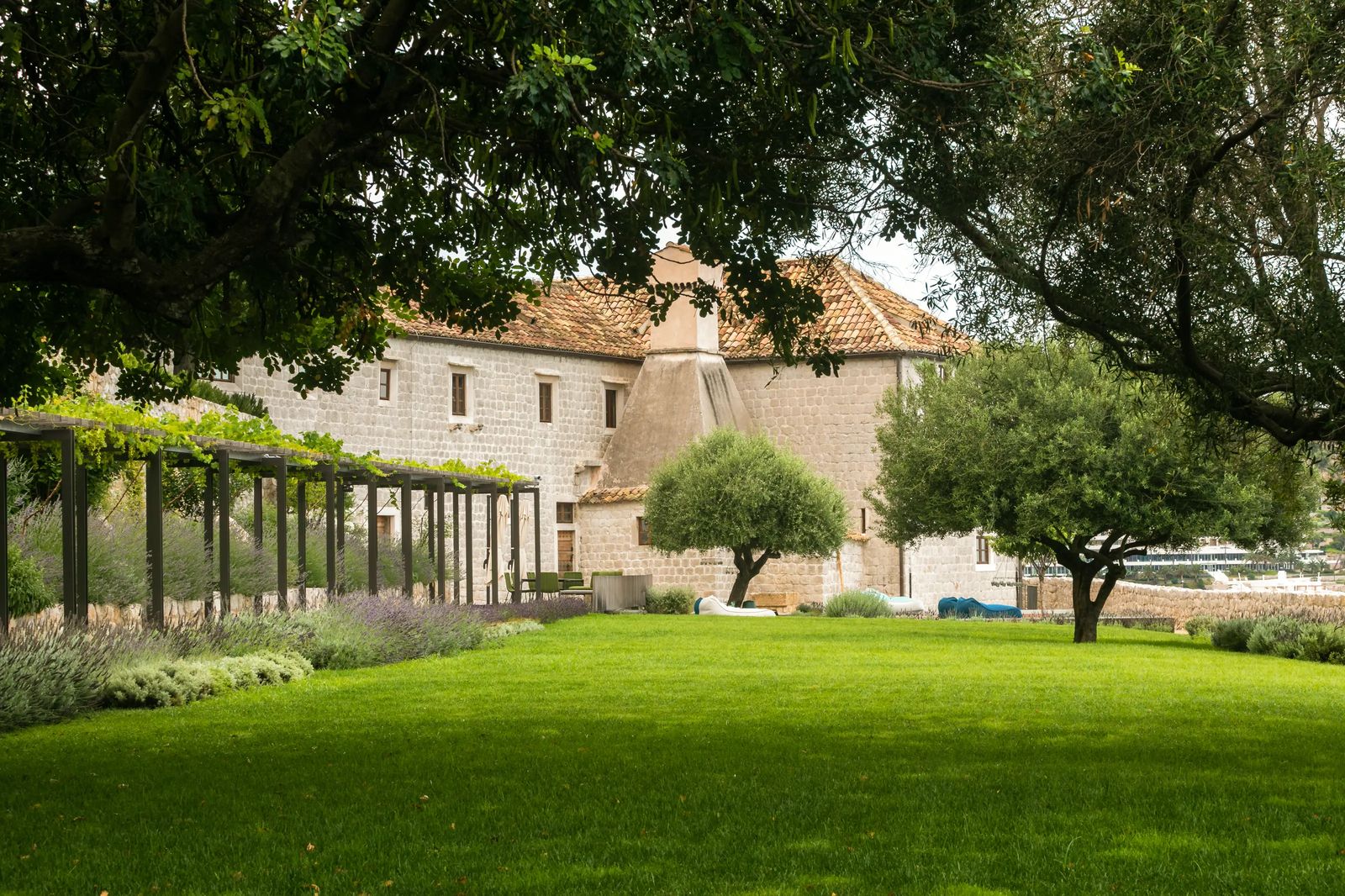 The cloister garden, a green lawn framed by the monastery's stone arcades