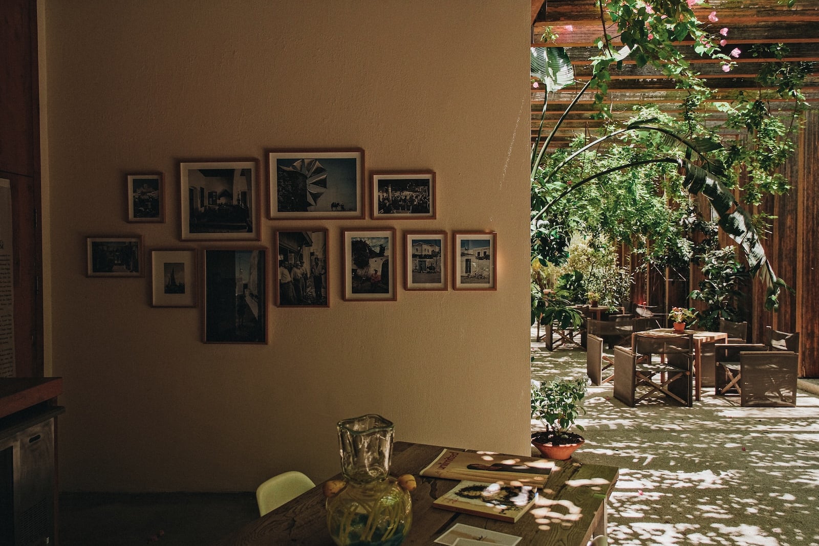 A shaded corner hung with framed photographs