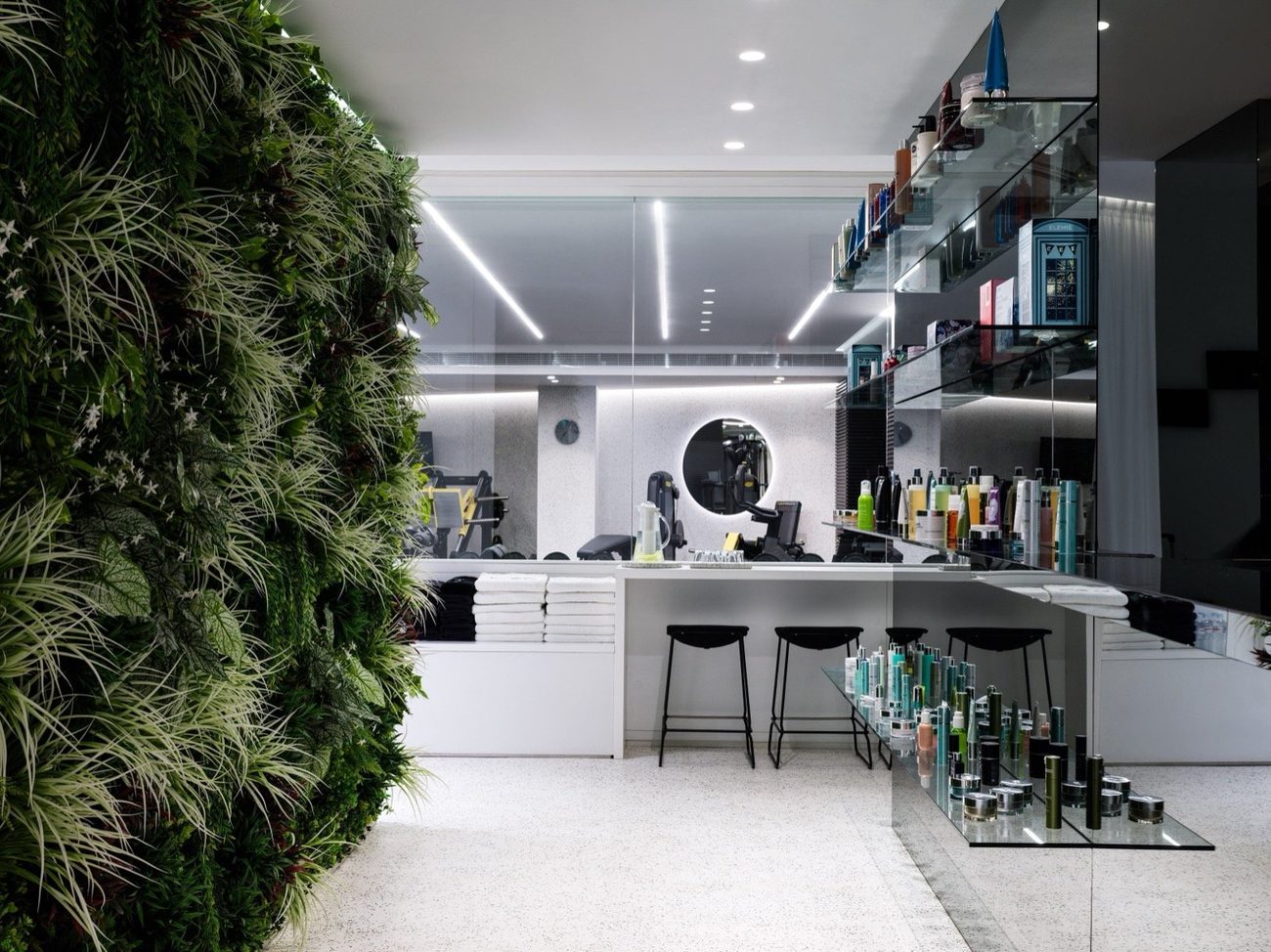 The spa and gym behind a living green wall, with Elemis products on glass shelves
