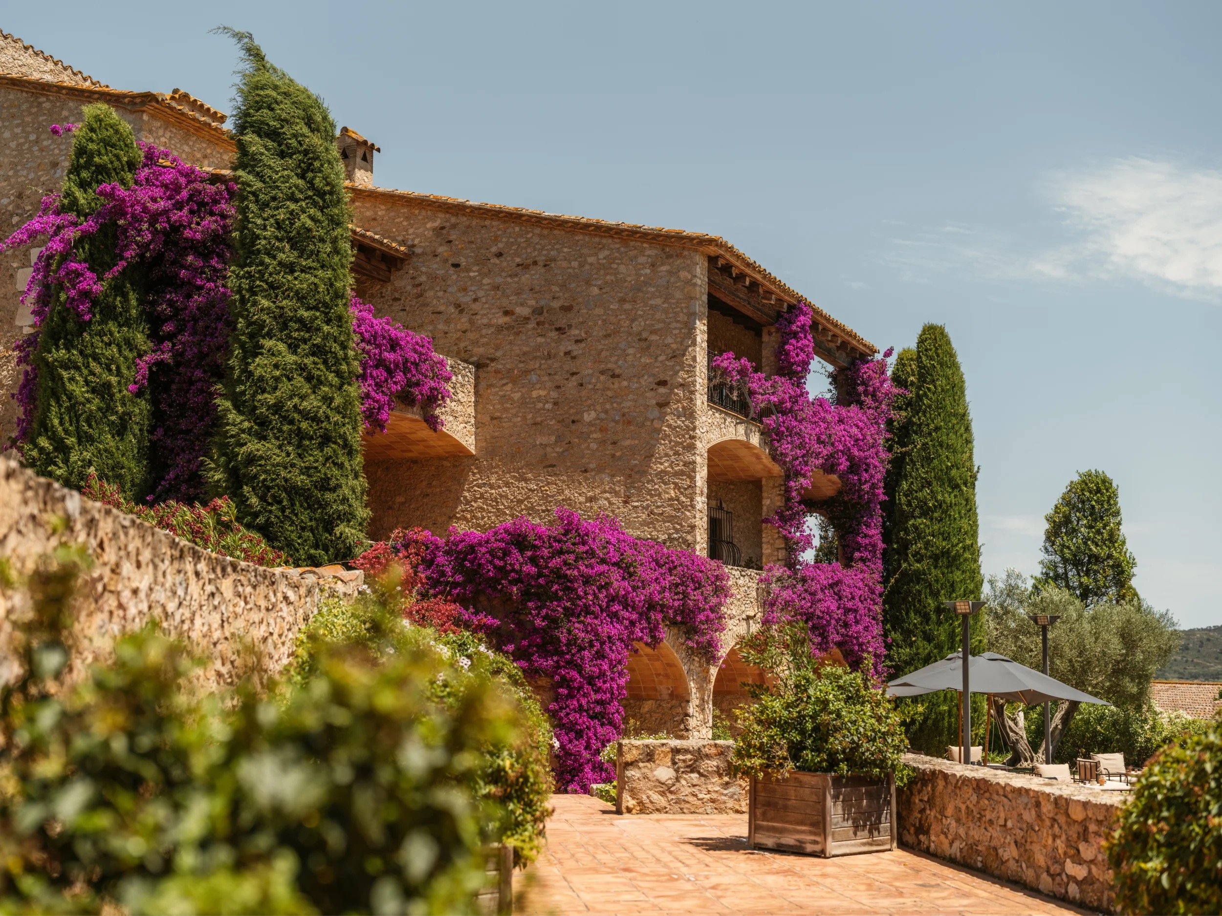 Bougainvillea across the stone facade of the old farmhouse