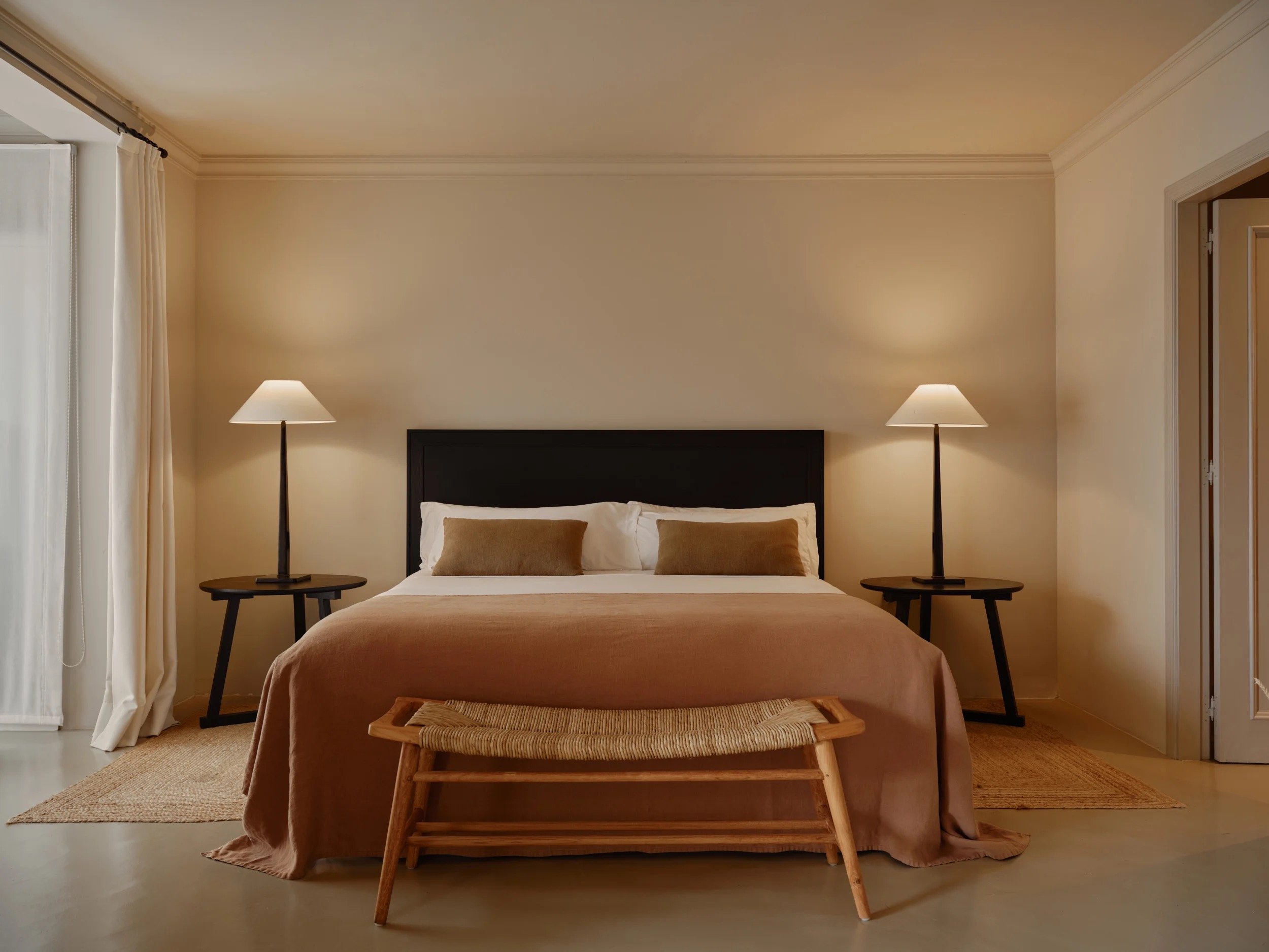 A garden-villa bedroom in warm, muted tones