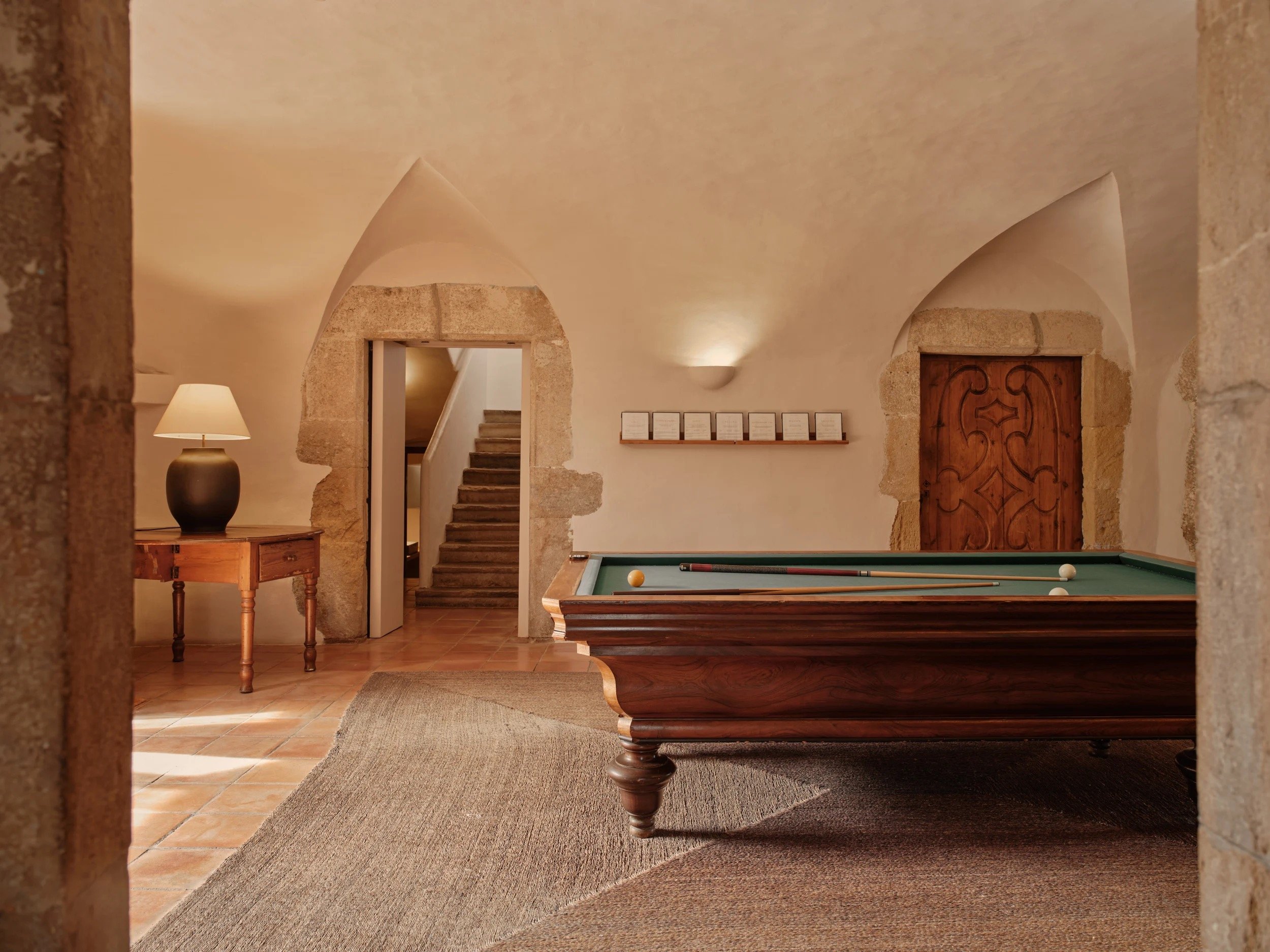 A vaulted sitting room with medieval stone arches