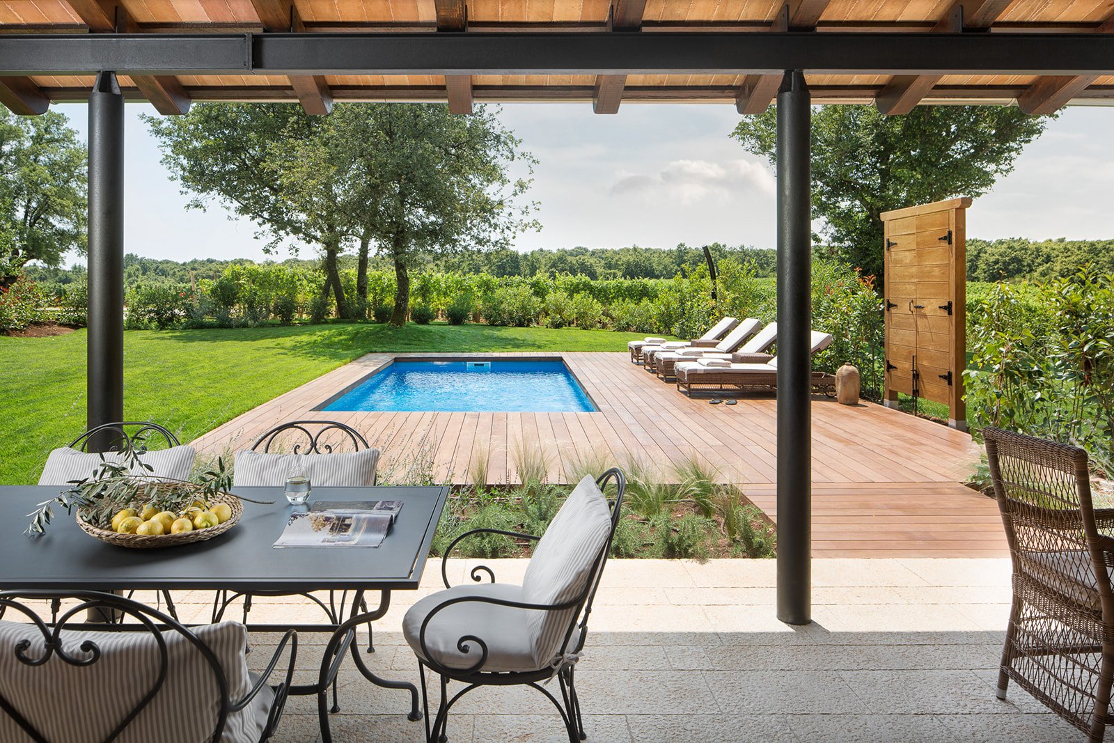 A private villa terrace looking onto its own pool and the vines