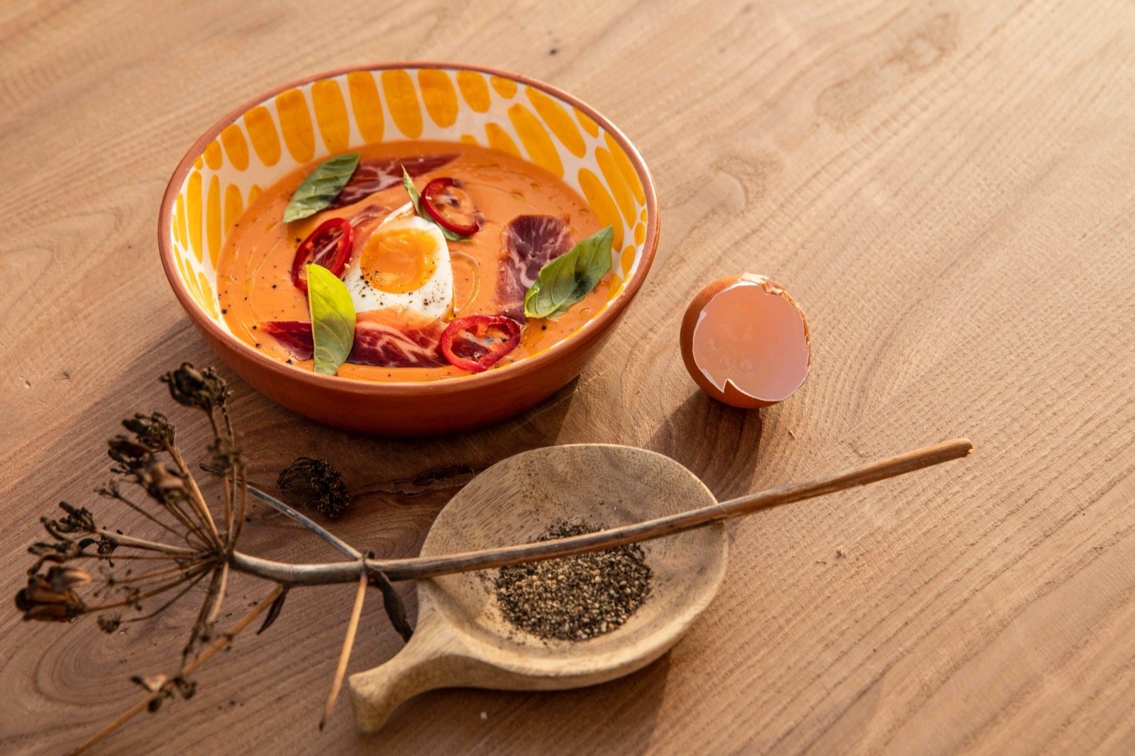 A cold tomato dish with jamón and a soft egg, from the kitchen