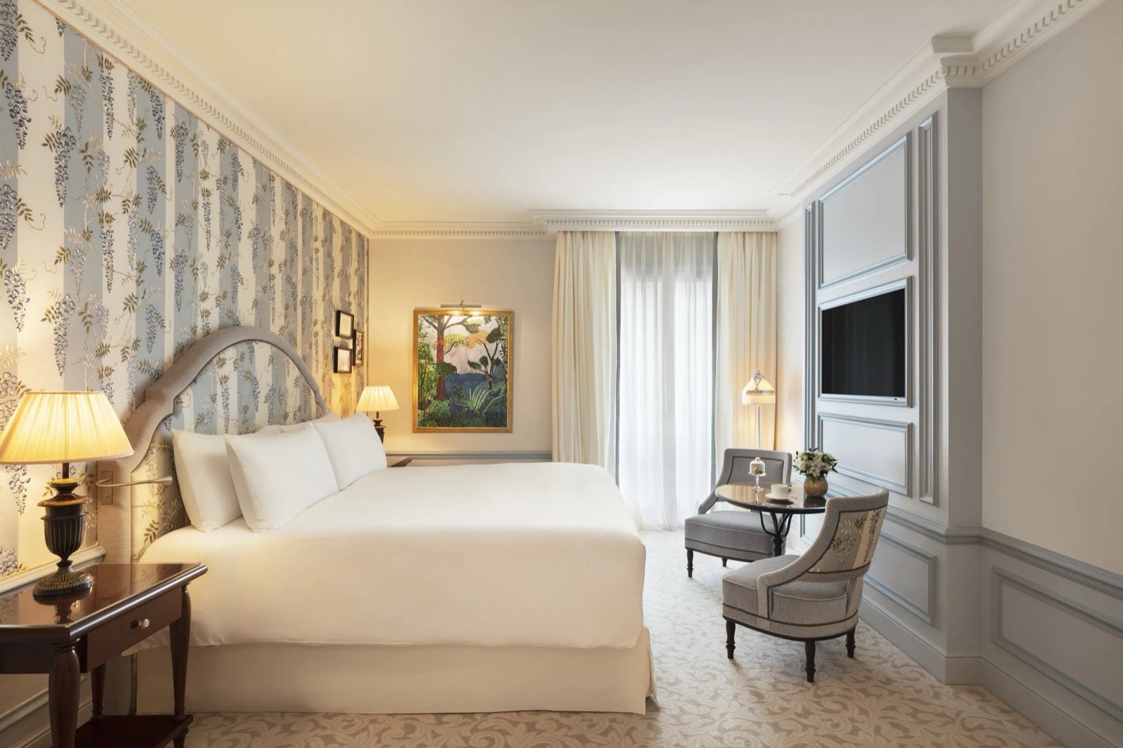 A room in the Jacques Garcia style, with patterned walls and antique furniture