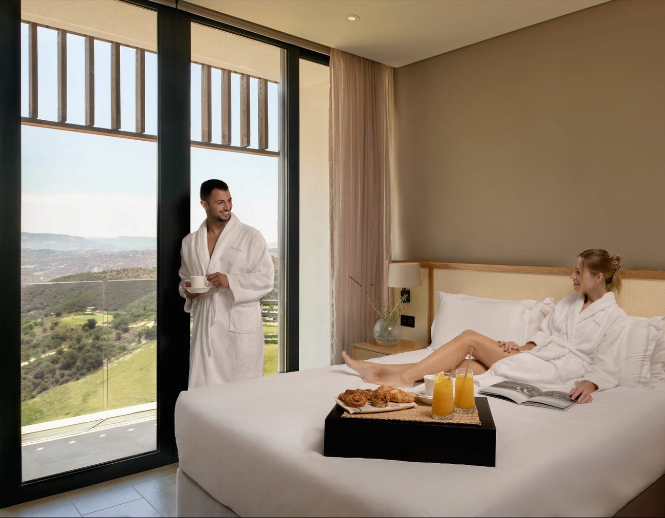 A suite bedroom opening to the wooded hills above Paphos