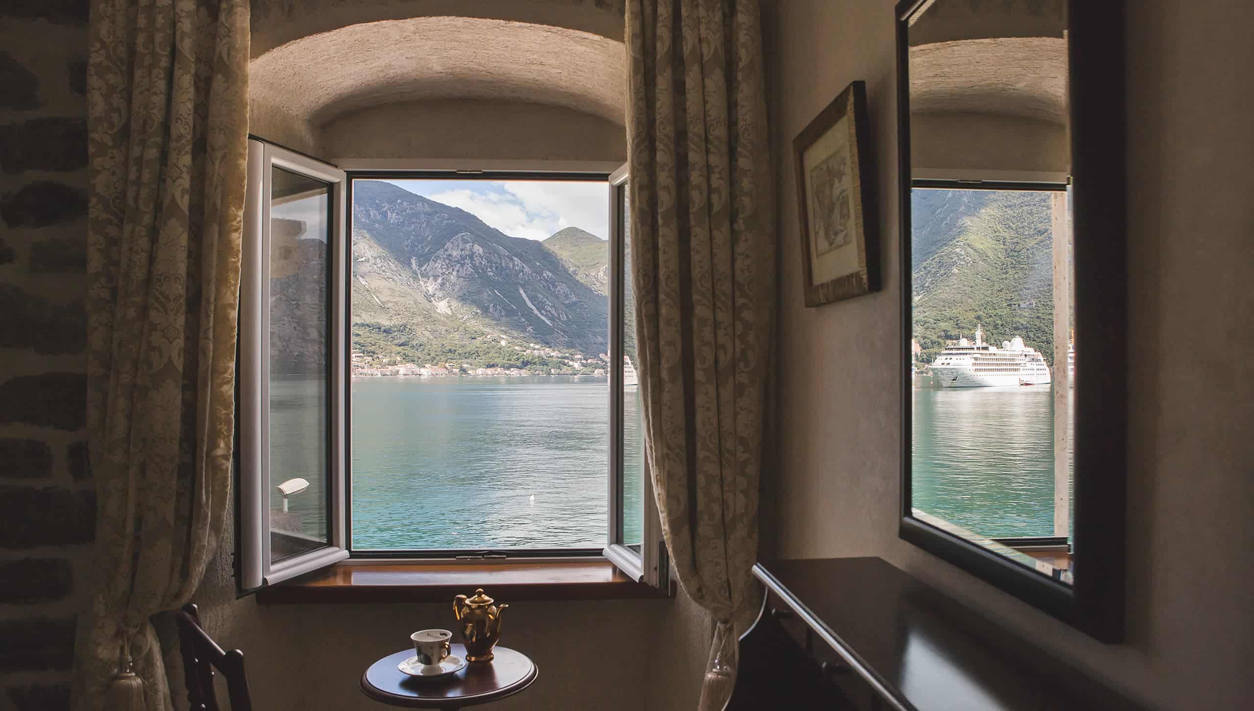 The Bay of Kotor and its mountains framed by a bedroom window