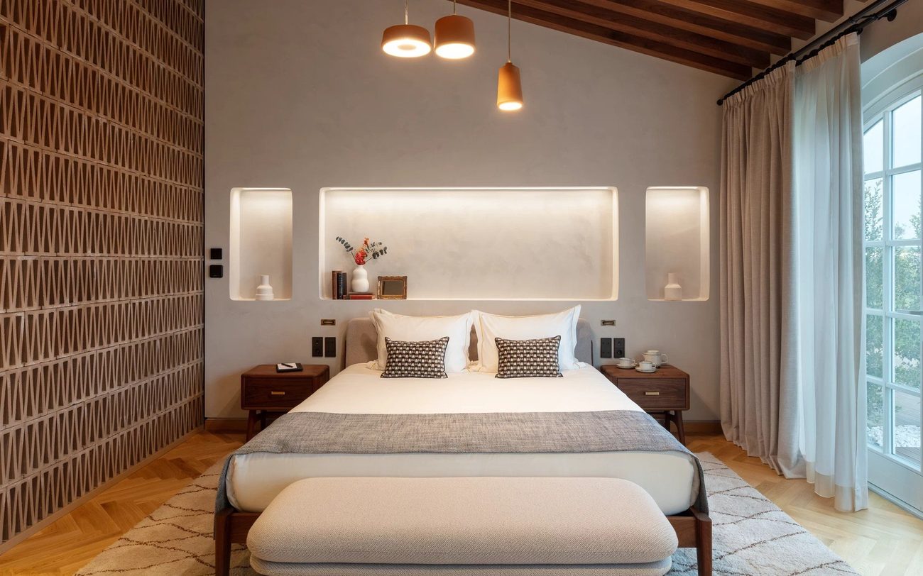 A signature suite with a perforated terracotta screen behind the bed