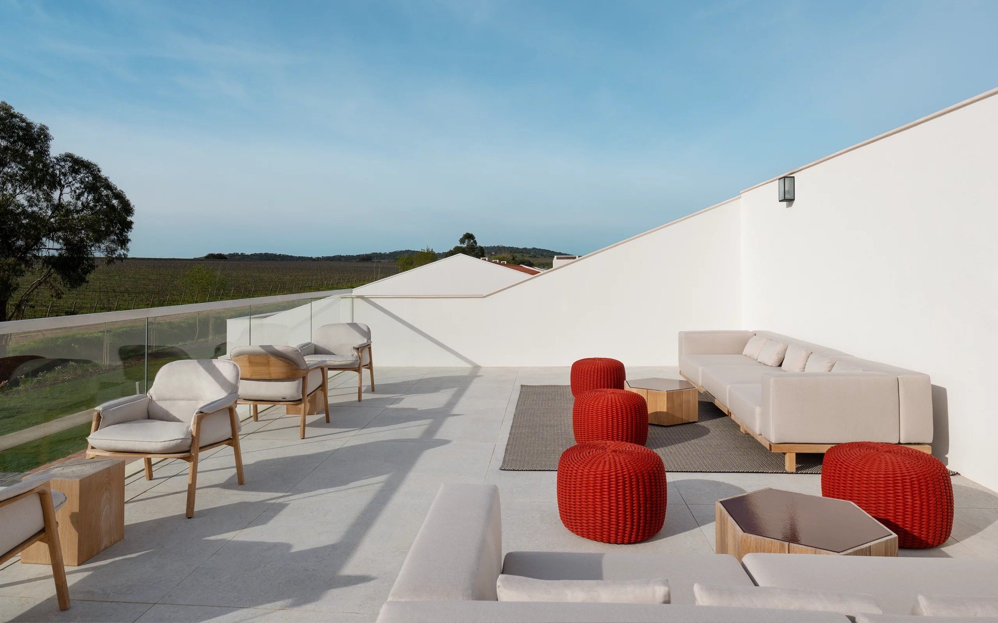 The Grape Rooftop terrace with red seating looking over the vineyard