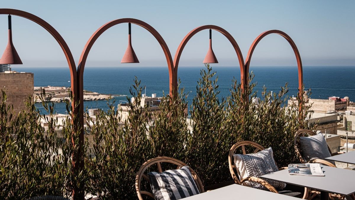 The rooftop terrace with olive trees and a view over the old city to the sea