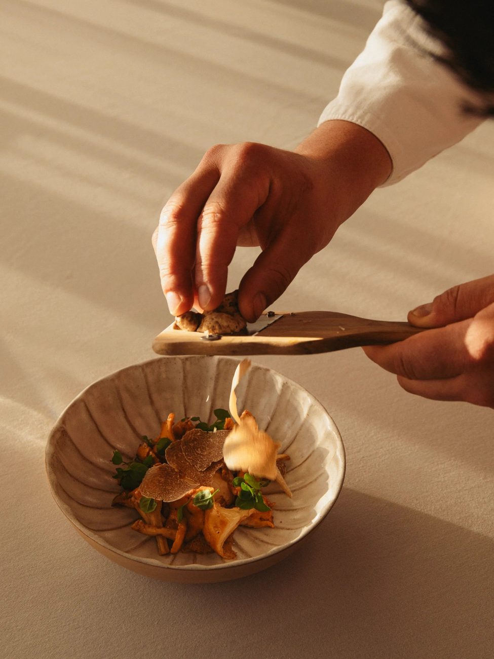 A dish being finished by hand at Luciano, the hotel's restaurant