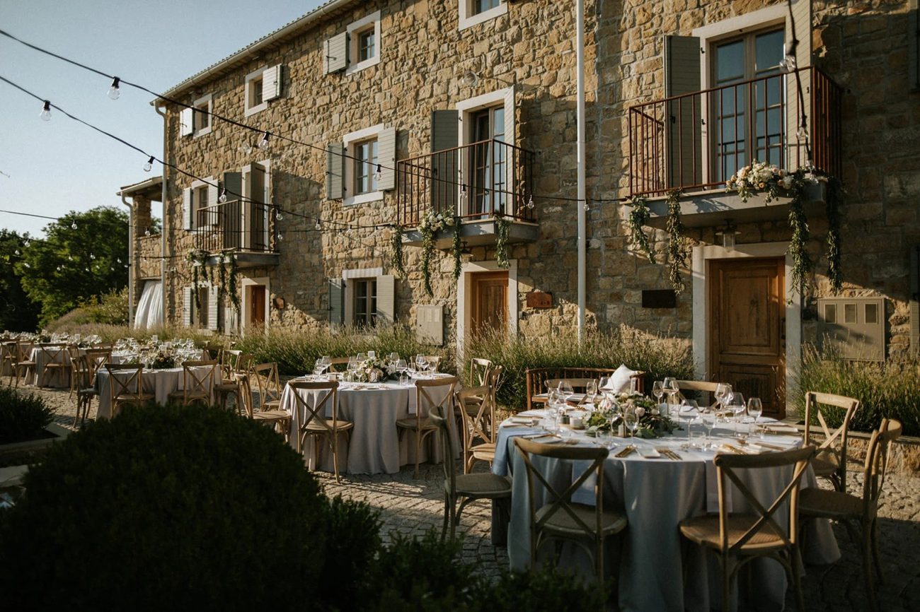 The restored stone buildings of the hamlet with the Istrian hills beyond