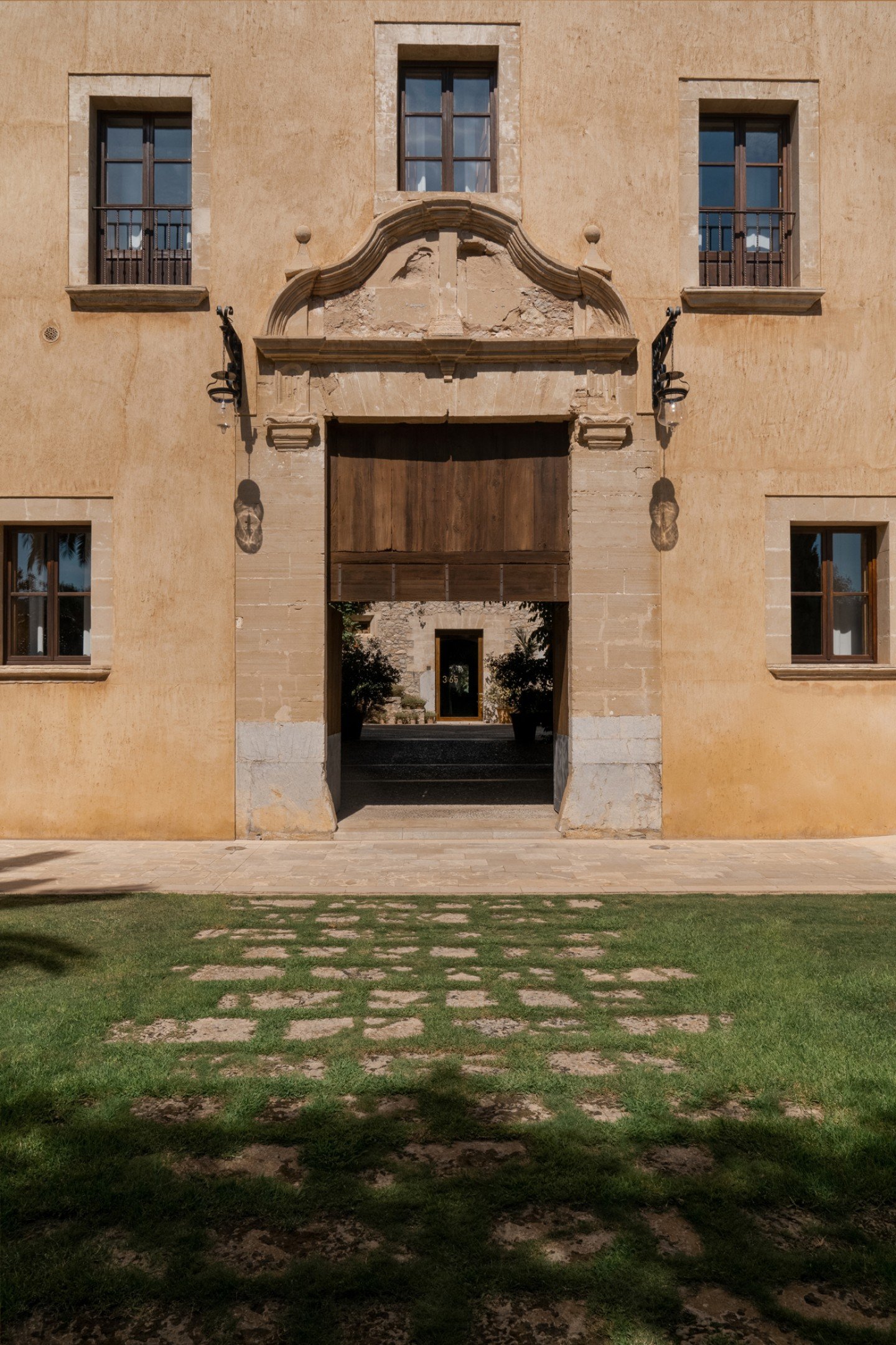 The 18th-century monastery facade, symmetrical windows above a stone forecourt
