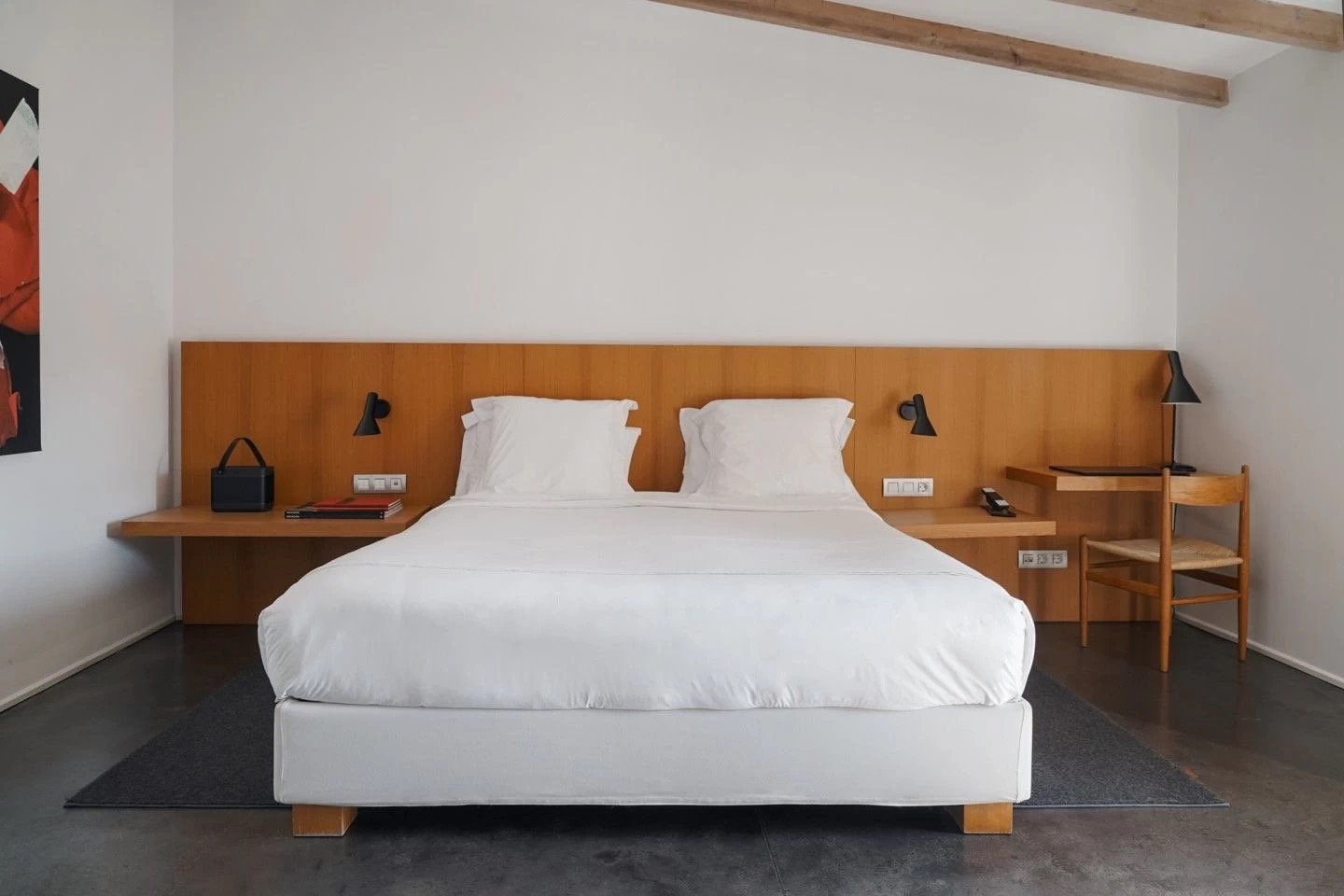 A pared-back room in pale wood and white linen