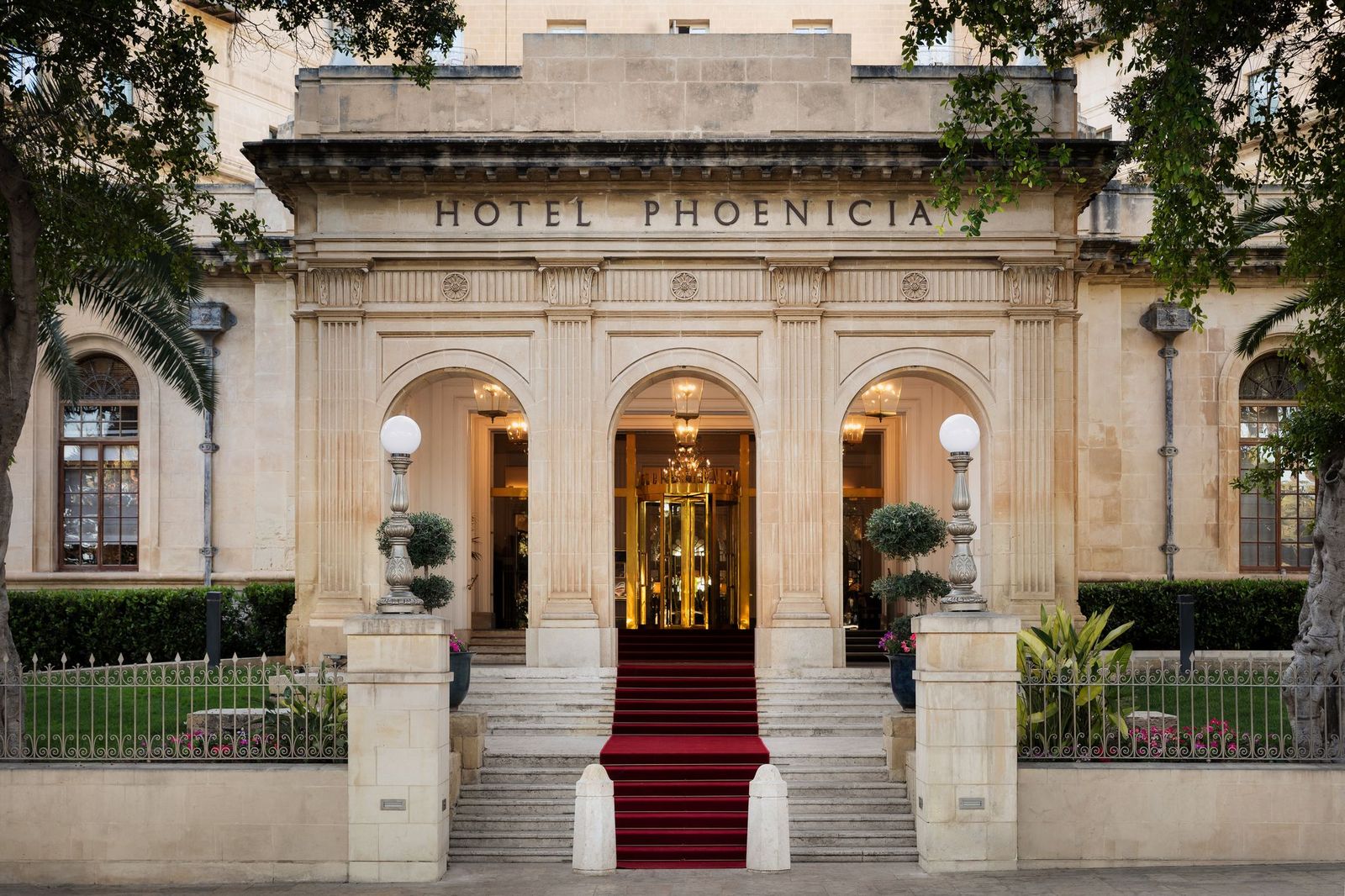 The 1947 Art Deco entrance with the Hotel Phoenicia name carved above the arches
