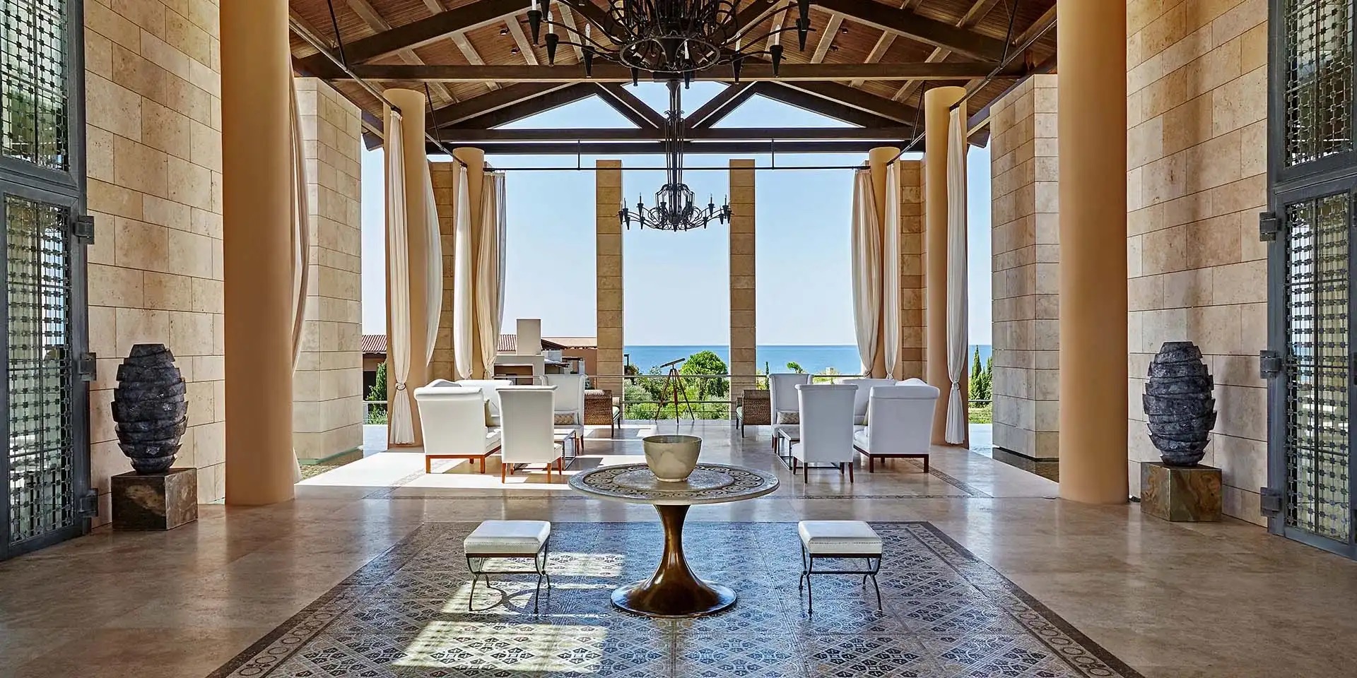 Column-lined lobby opening to the sea at The Romanos