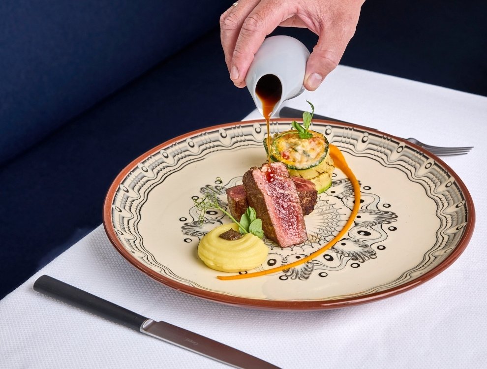 A dish at Xtian, plated on hand-painted ceramic