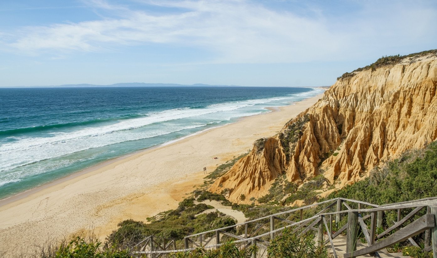 The long Atlantic beach and ochre cliffs of the Comporta and Melides coast