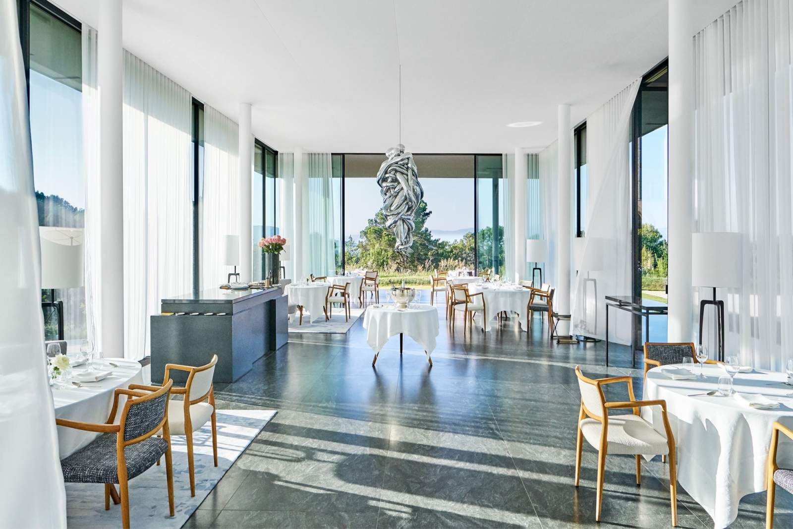The dining room, a Louise Bourgeois sculpture hung against the vineyard view