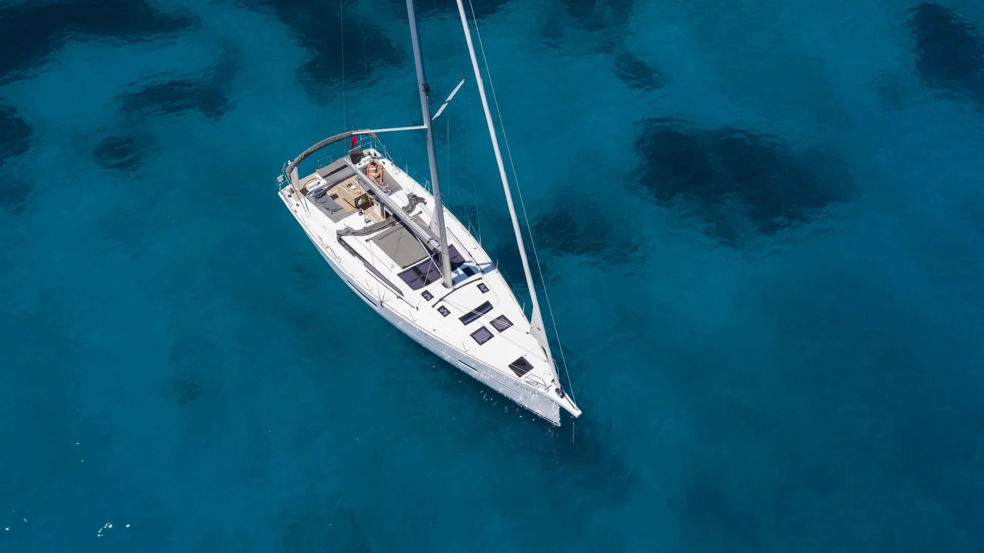 The hotel's sailing yacht anchored over clear turquoise water