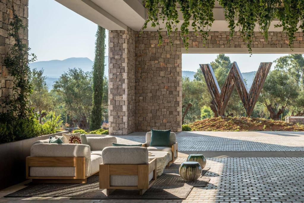 Daytime lounge terrace with the W sculpture and mountains beyond